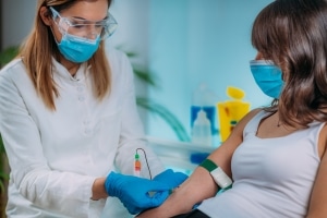 Medical professional taking a blood sample