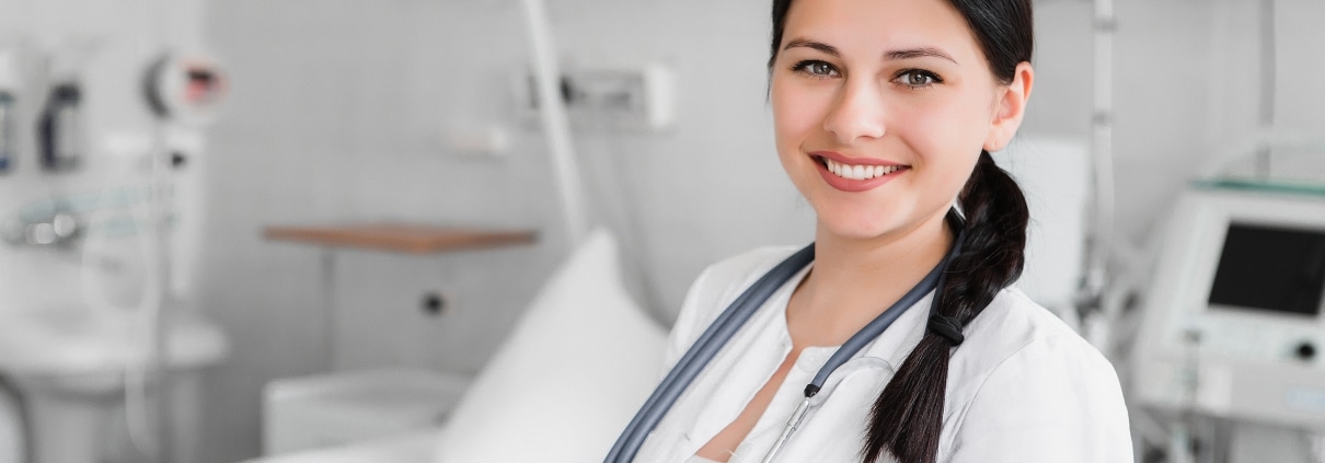 Healthcare worker in front of a hospital bed