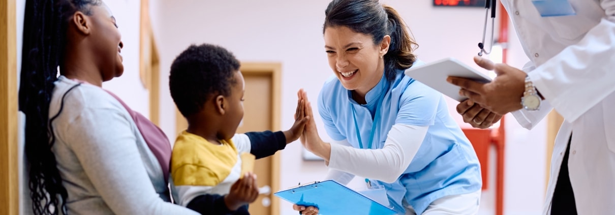 Medical professional giving a high five to a child