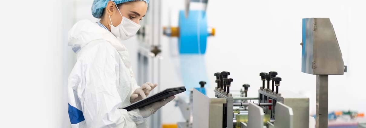 Young professional in sterile clothes checking medical equipment
