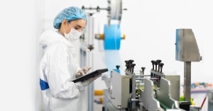 Young professional in sterile clothes checking medical equipment